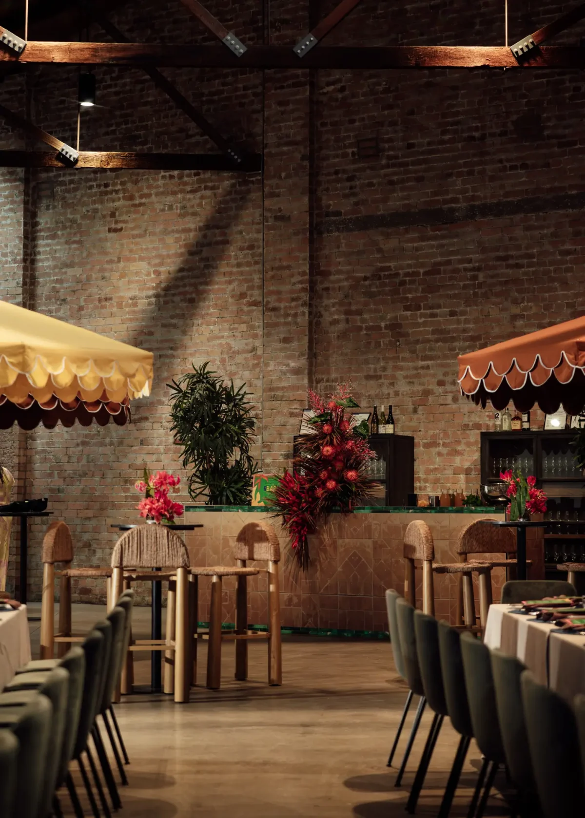 The Mill at Half Acre styled for a brand event with a floral bar, rattan stools and scalloped umbrellas