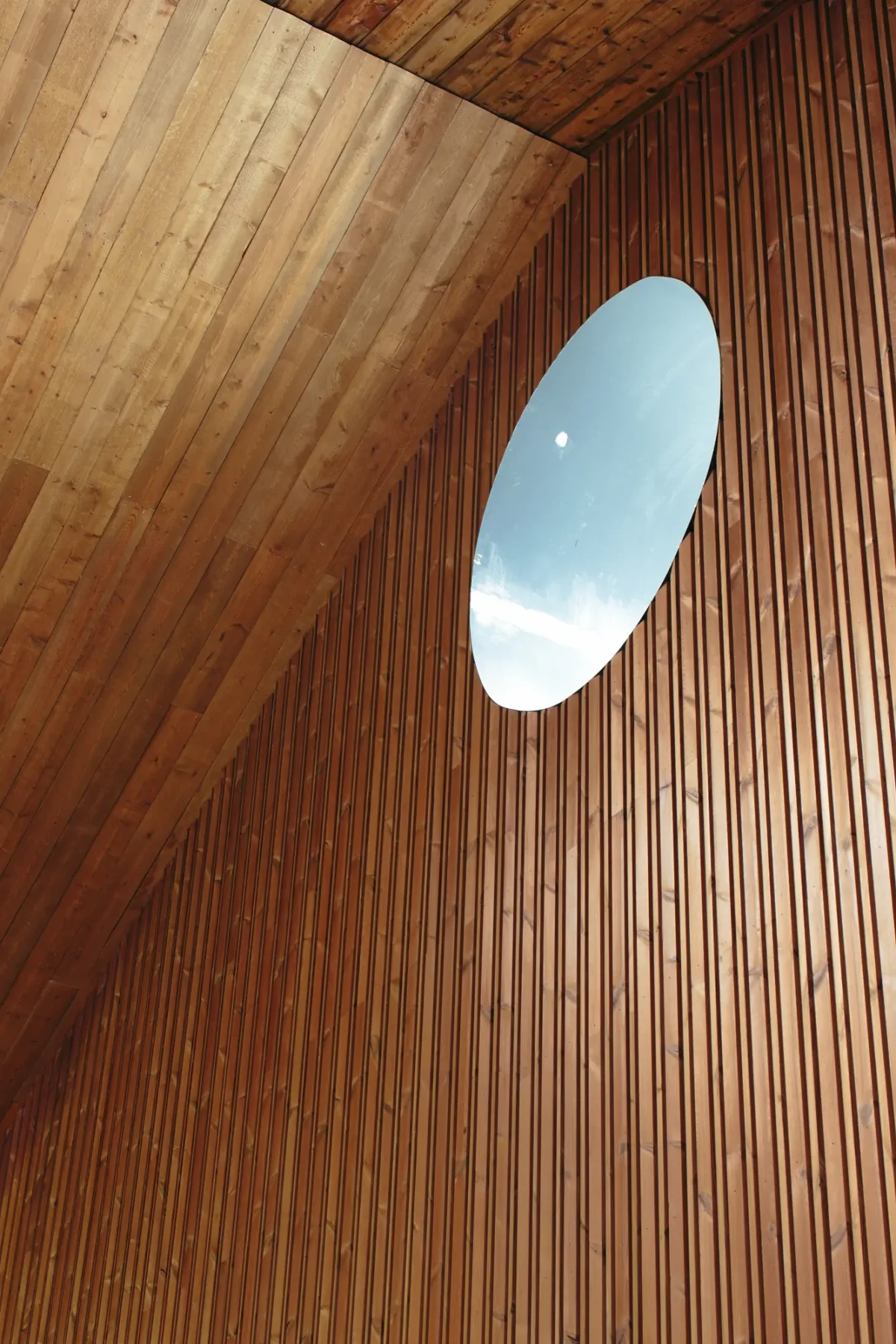 Oval skylight set into the timber-battened wall and ceiling of The Mill at Half Acre