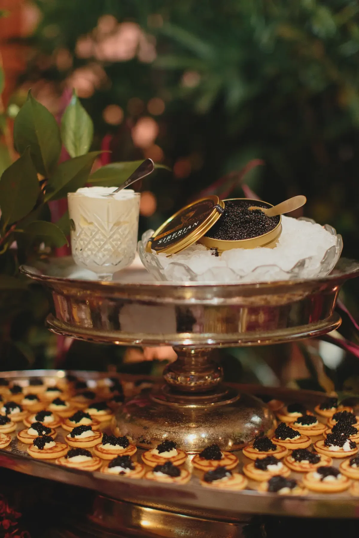 Caviar service on a silver stand with blinis at a Half Acre event